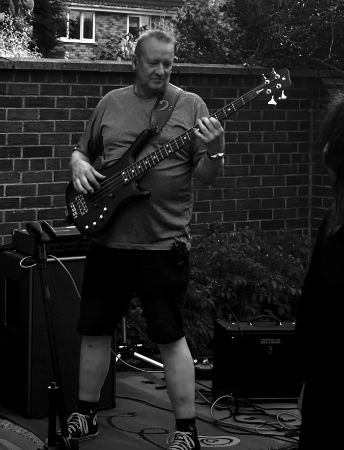 Bass player performing in a garden